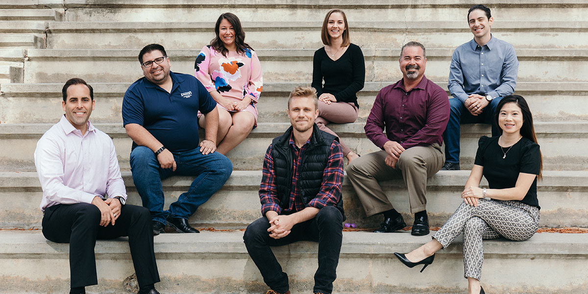 The MBA8 students sitting on amphitheatre steps